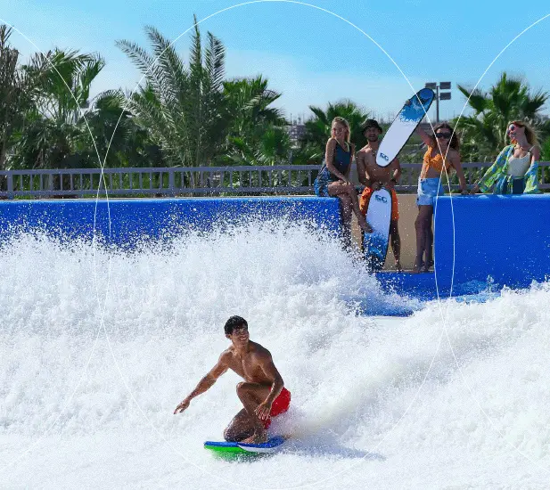 Surfer catching a wave at Verona Damac Hills, a surfing paradise